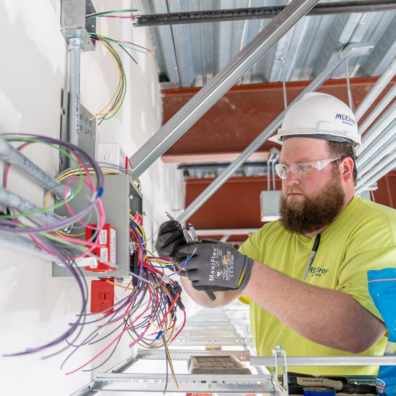 McElroy Electric electrician works on wiring for building automation.